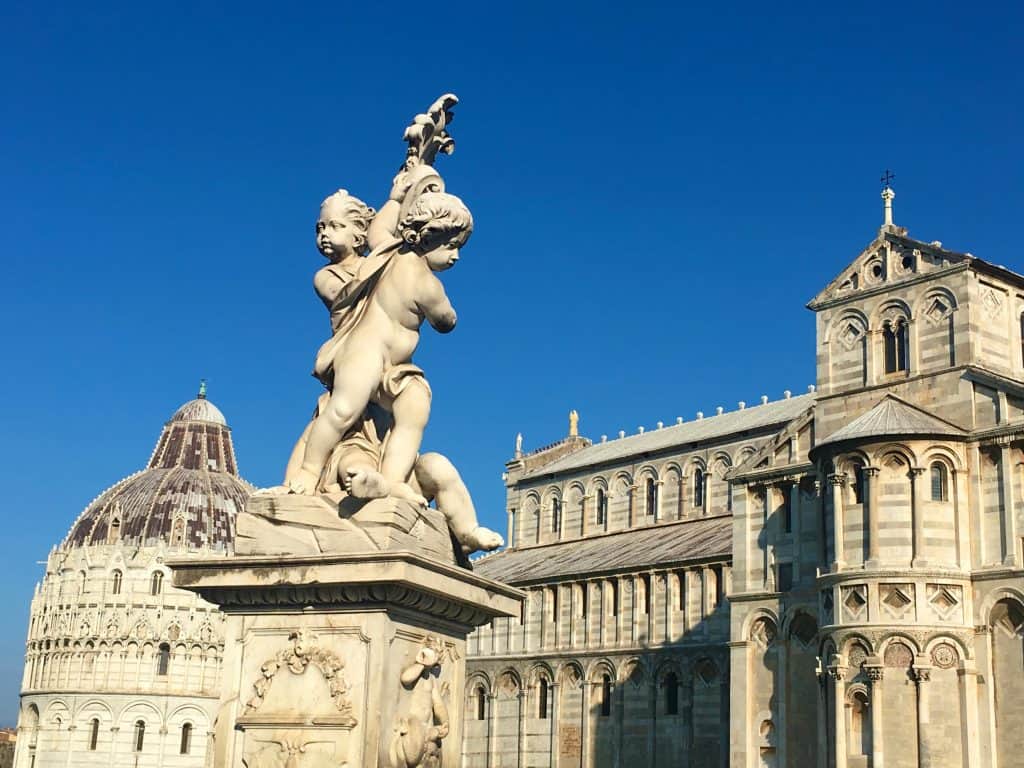 One day in Pisa: Statue of cherubs with Pisa Cathedral in background