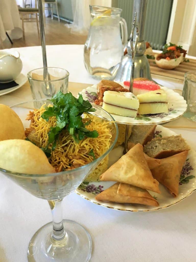 Cake stand with samosas, dhokra, bhel puri and mithai