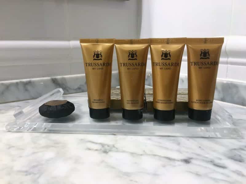 An opulent stay at The Bernini Palace Hotel, Florence An opulent stay at The Bernini Palace Hotel, Florence 4 bronze bottles of Tressard toiletries and a soap coloured in clack tissue. These are on a plastic oblong plate which rests on on a white and grey marble surface.