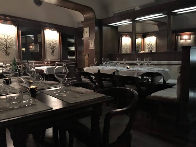 Sampling the fine dining scene in Florence The dark wood decor and set tables with cutlery and wine glasses of Il Barretto.
