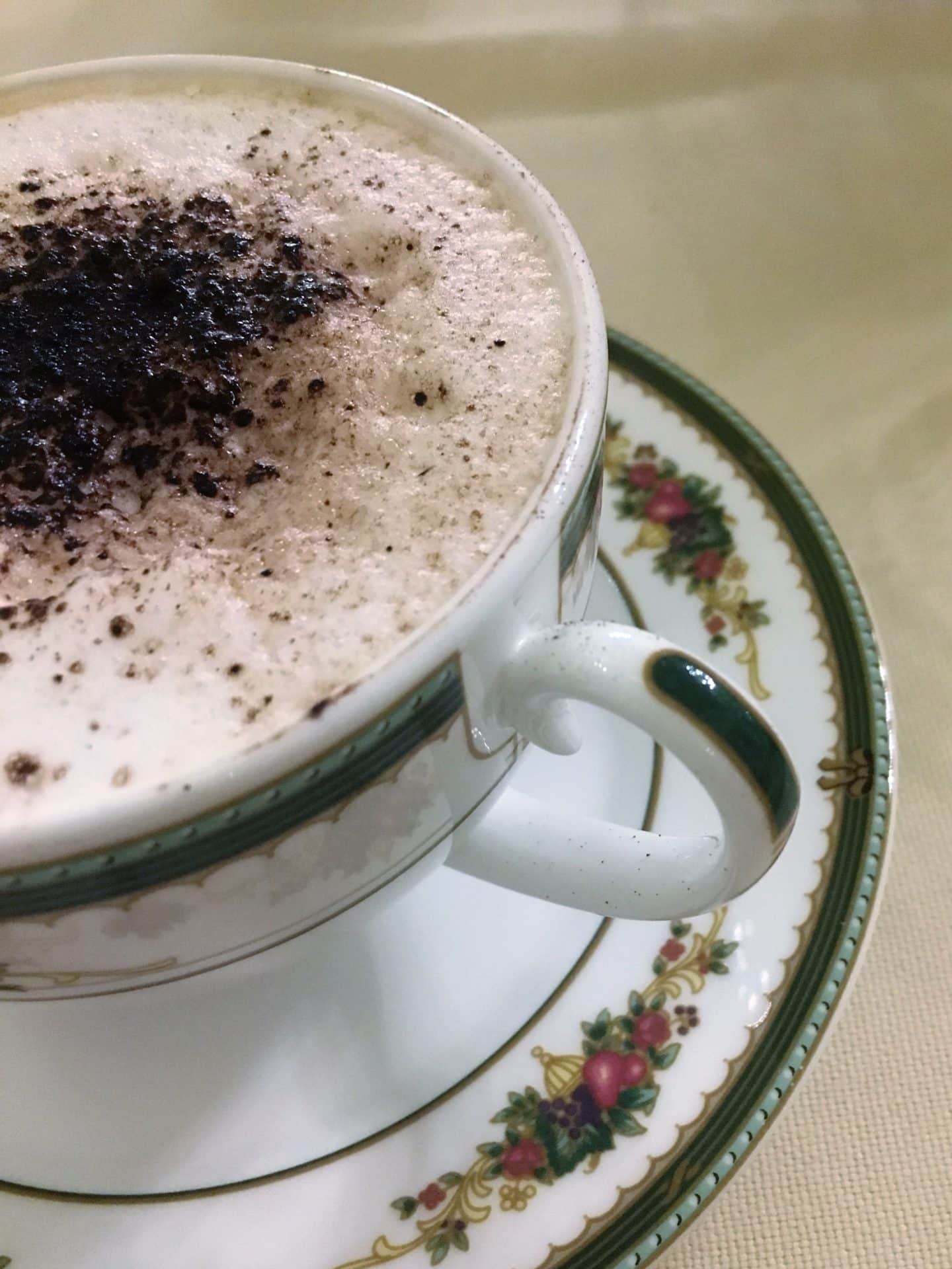 The Opulent Bernini Palace Hotel breakfast cappuccino. A breakfast cup of cappuccino with a flowery saucer.