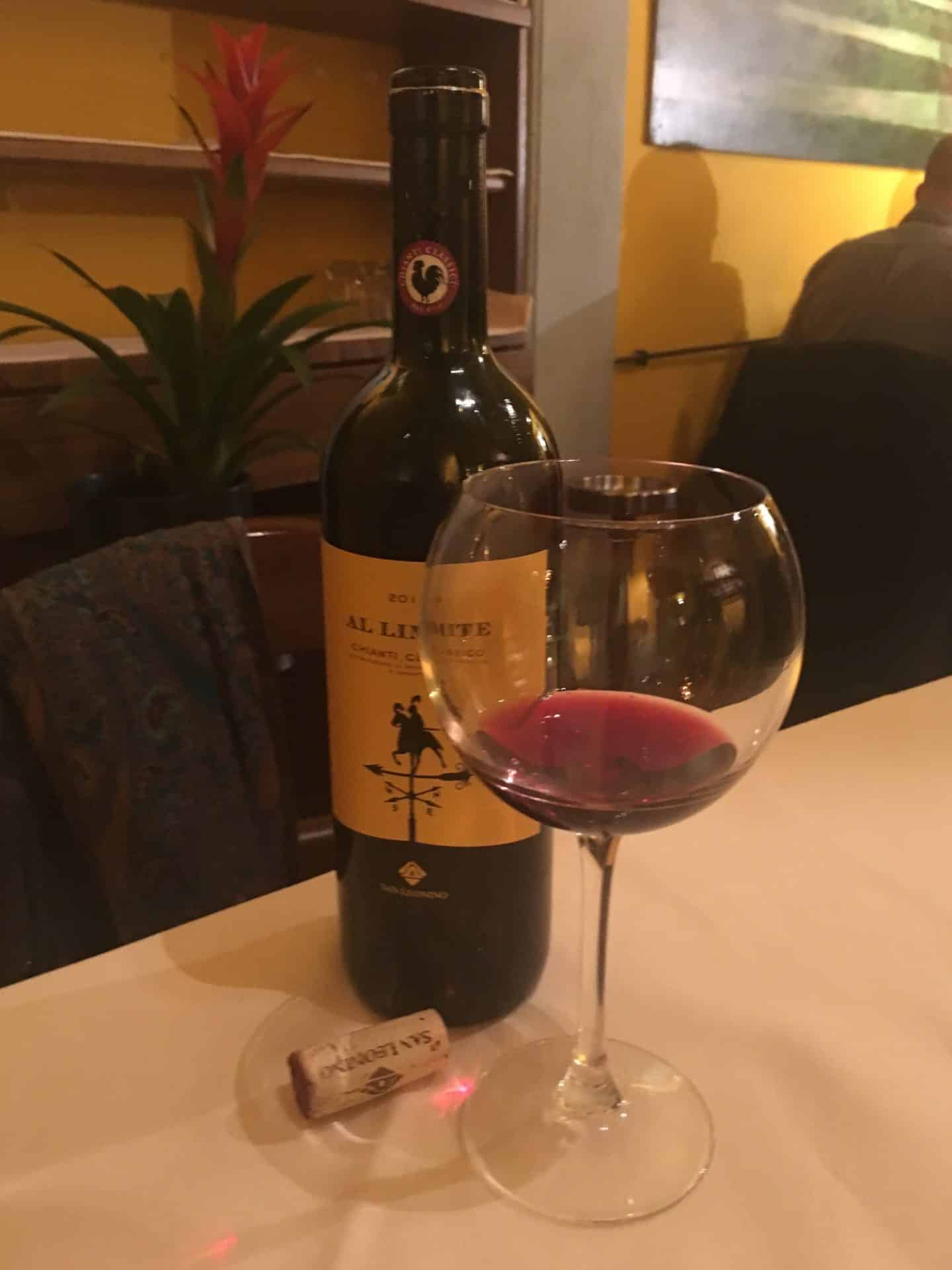 Sampling the fine dining scene in Florence Fine dining restaurants in Florence - A bottle of red wine and a glass at Parione.