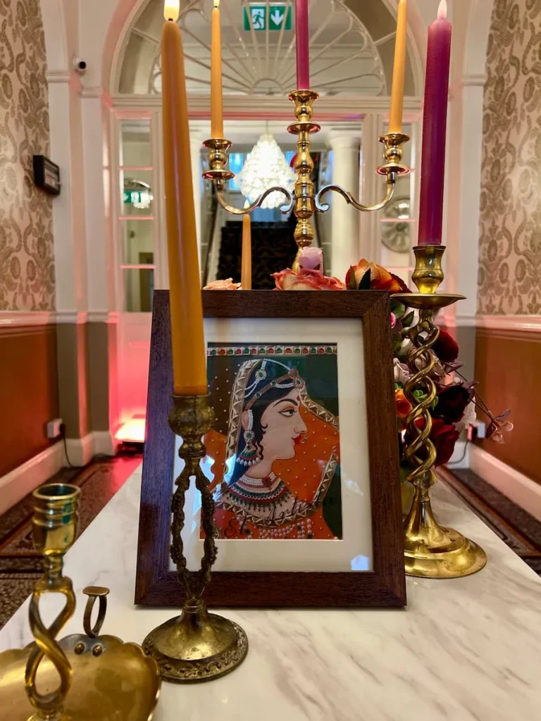 Indian Afternoon Tea At the City Rooms, entrance decor with photos and floral bouquets with the staircase in the background