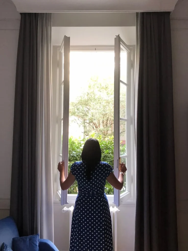 Bejal standing at window of suite at Lungarno Vespucci 50, Florence