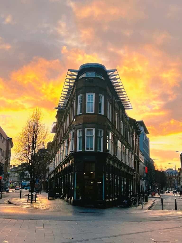 The exterior of The Exchnage Bar with a sunset behind it, in Leicester