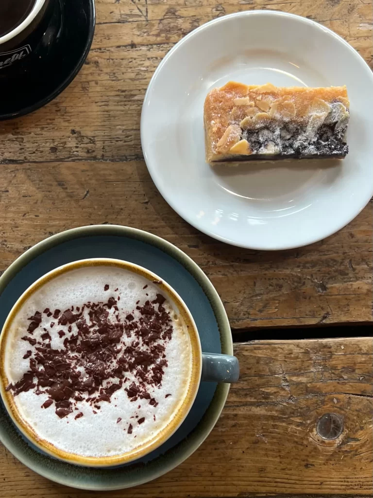 Cappuccino and blueberry Bakewell flat lay photo at Ninety Six Degrees Cafe, Leicester