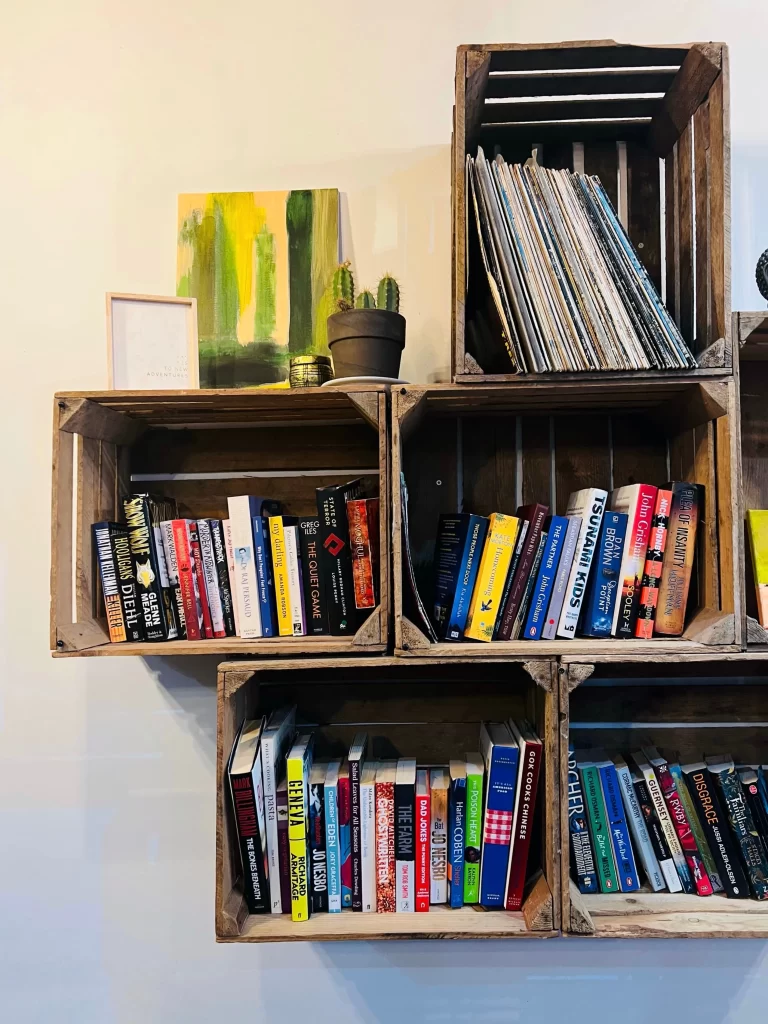 Wall hung book shelves with books and records at Ninety Six Degrees Cafe, Leicester