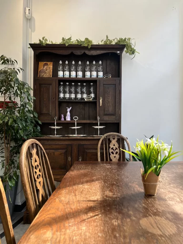 Dark wood side board with china tea stands in 5 coats cafe, Leicester