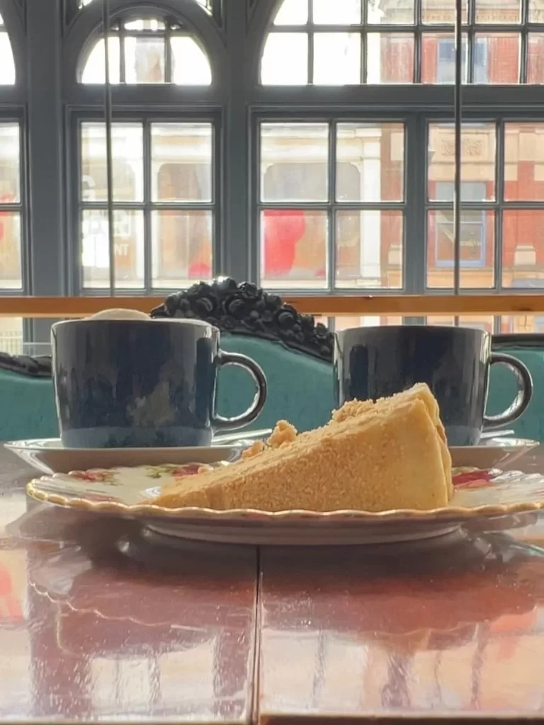 Coffee and honey cake in blue crockery at 5 coats cafe in Leicester