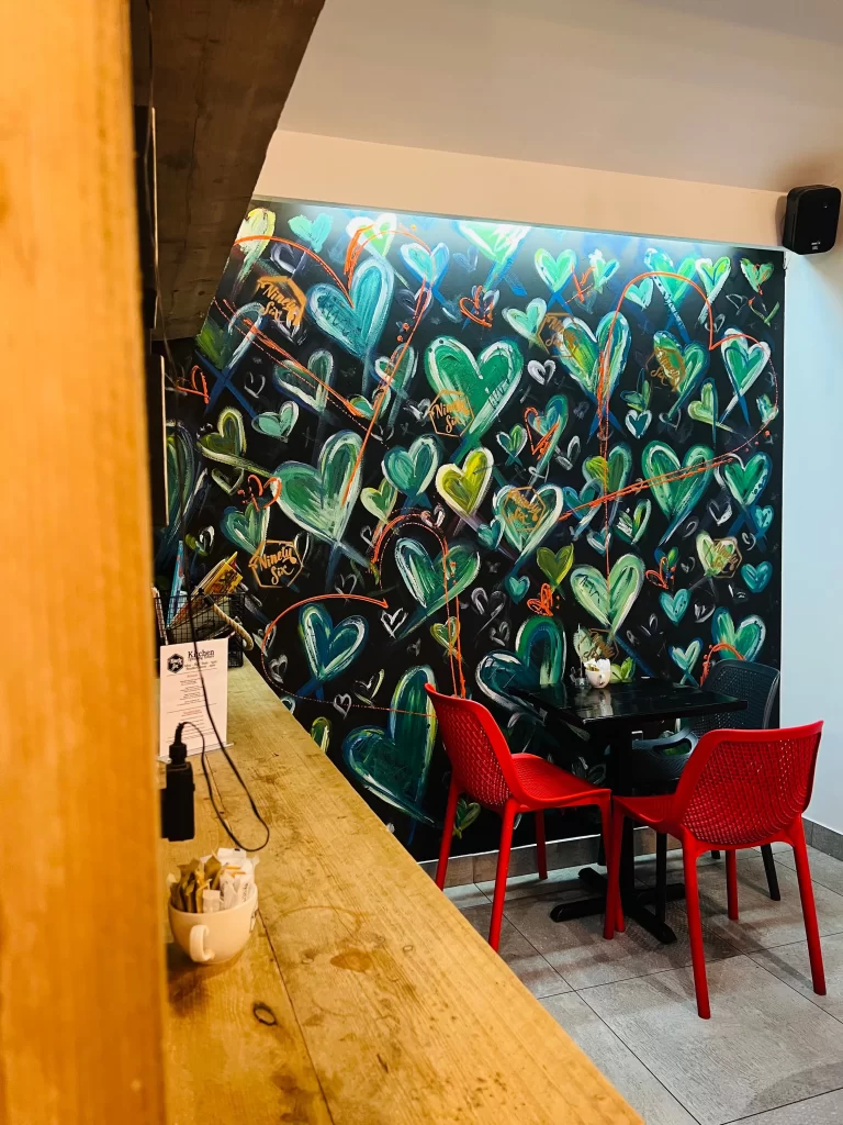 The artwork feature wall with colourful hearts at Ninety Six Degrees Cafe, Leicester