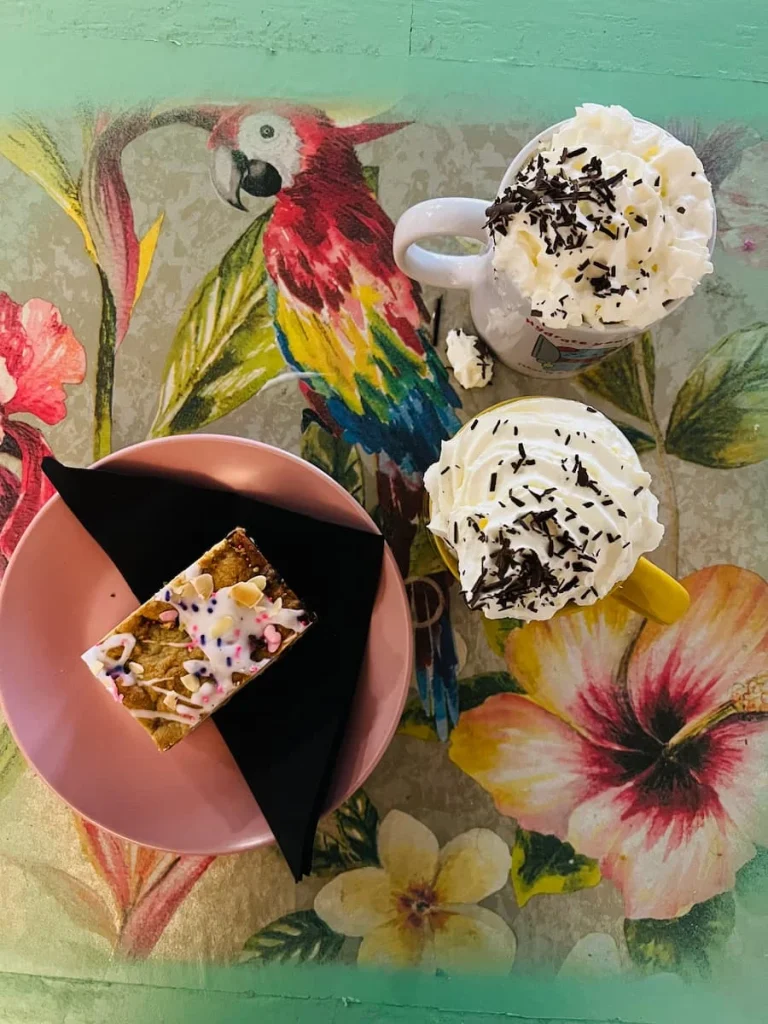 Bakewell cookie slice top ay with hot chocolate topp[ed with cream at Bitsys Emporium, Leicester