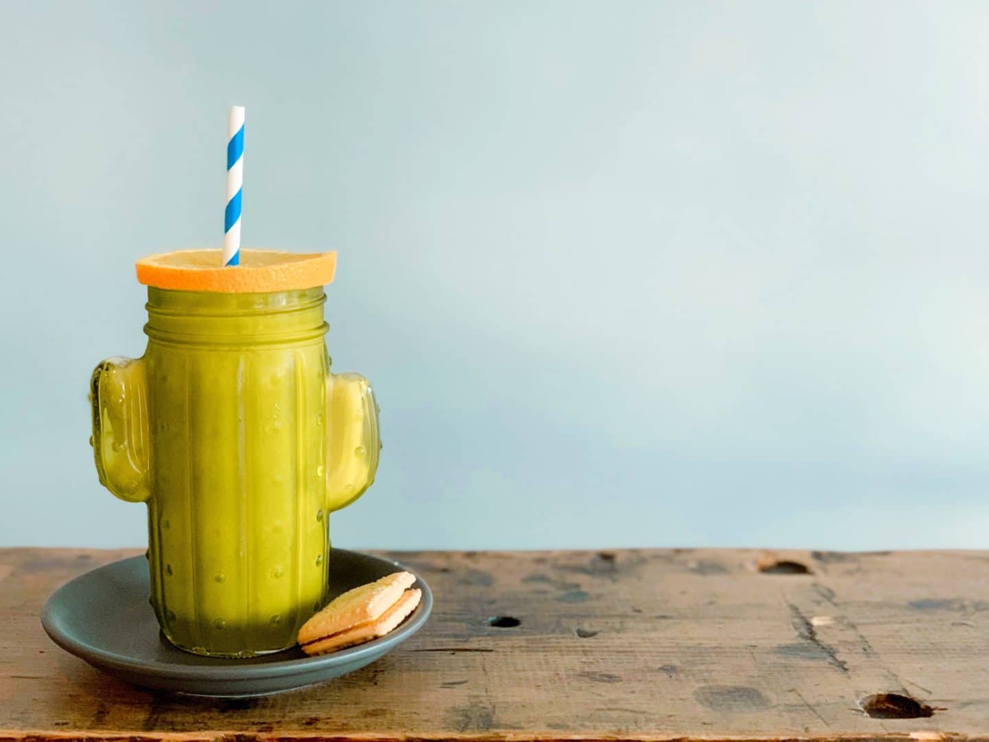 Independent Coffee Shops in LE1, Leicester. A fresh juice in a cactus cup with a custard cream on the side at Orso Cafe.