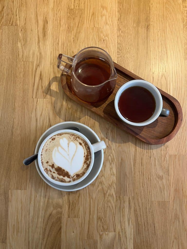 Cappuccino and a black filter coffee top lay at Saints of Mokha, Leicester