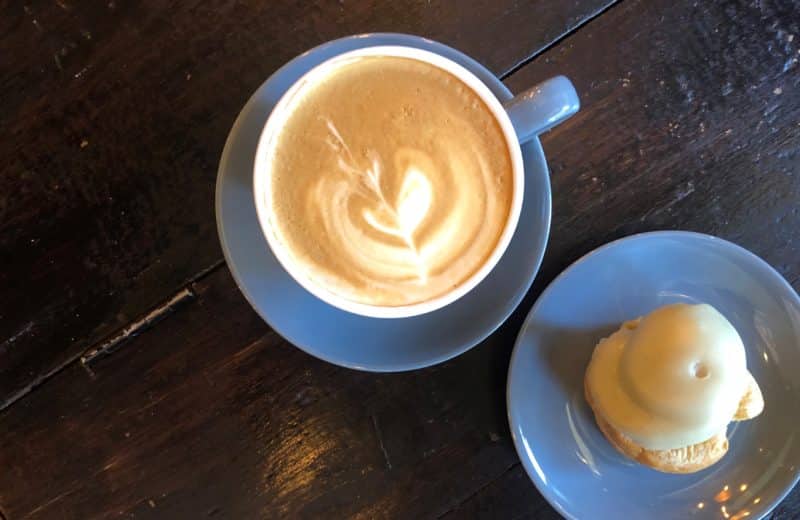 Independent Coffee Shops in LE1, Leicester. A top lay of a blue cup with latte and an Italian pastry at Merchant of Venice,