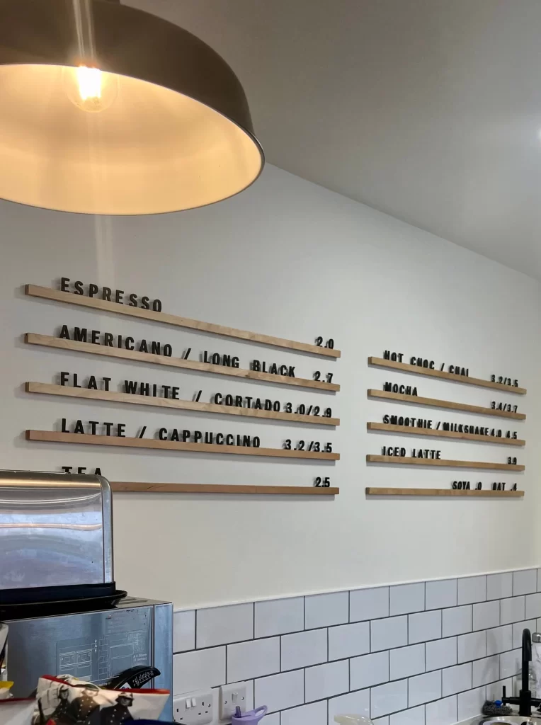 Wall coffee at One Church, Leicester. Hote drinks menu on wall