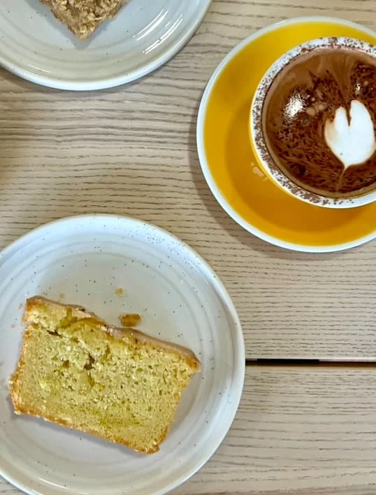Mocha and lemon drizzle cake slice flatlay at Way cafe, One Church, Leicester