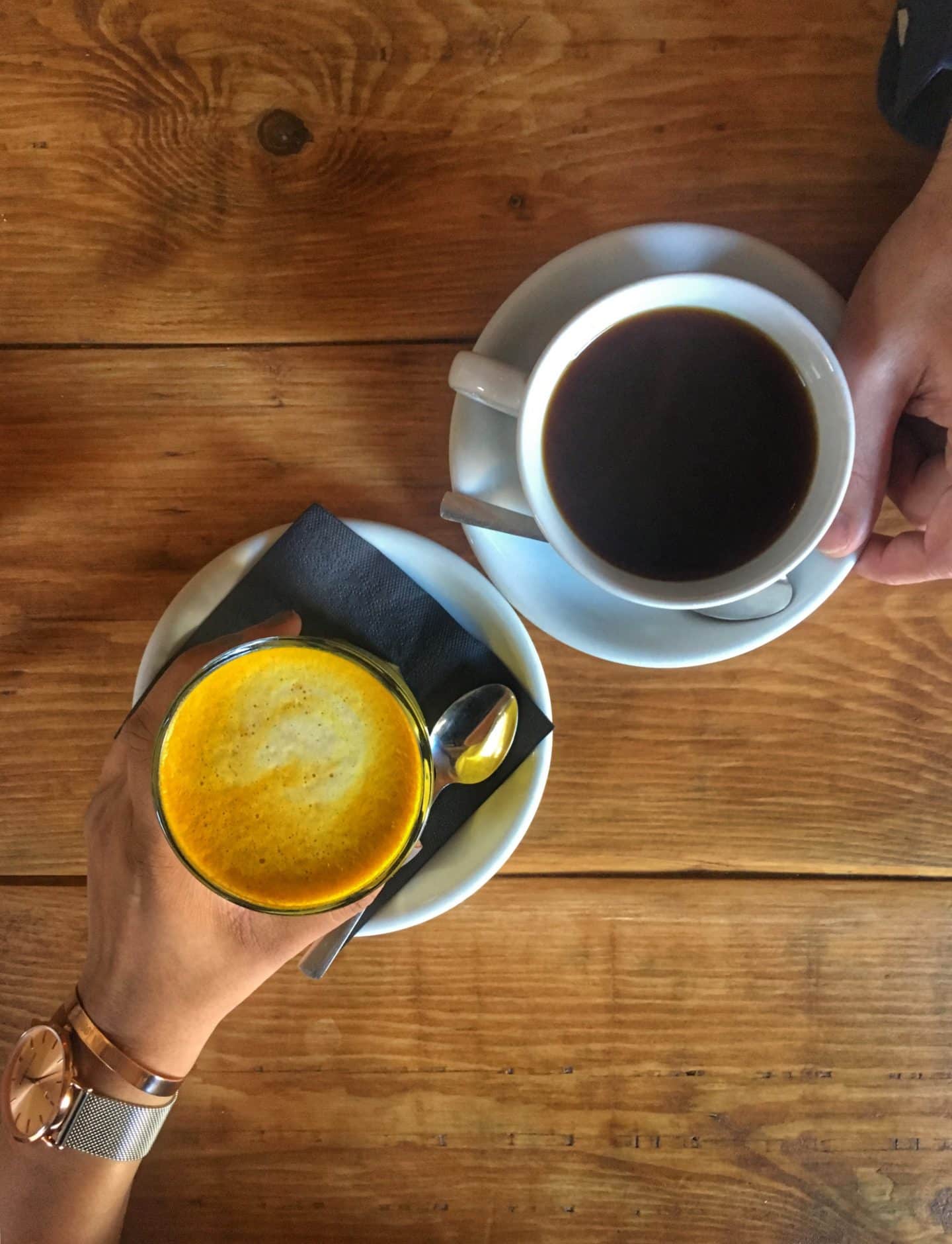 LE1:Independent Coffee & Cake Locales. Kai Kitchen with turmeric latte and black coffee top lay.