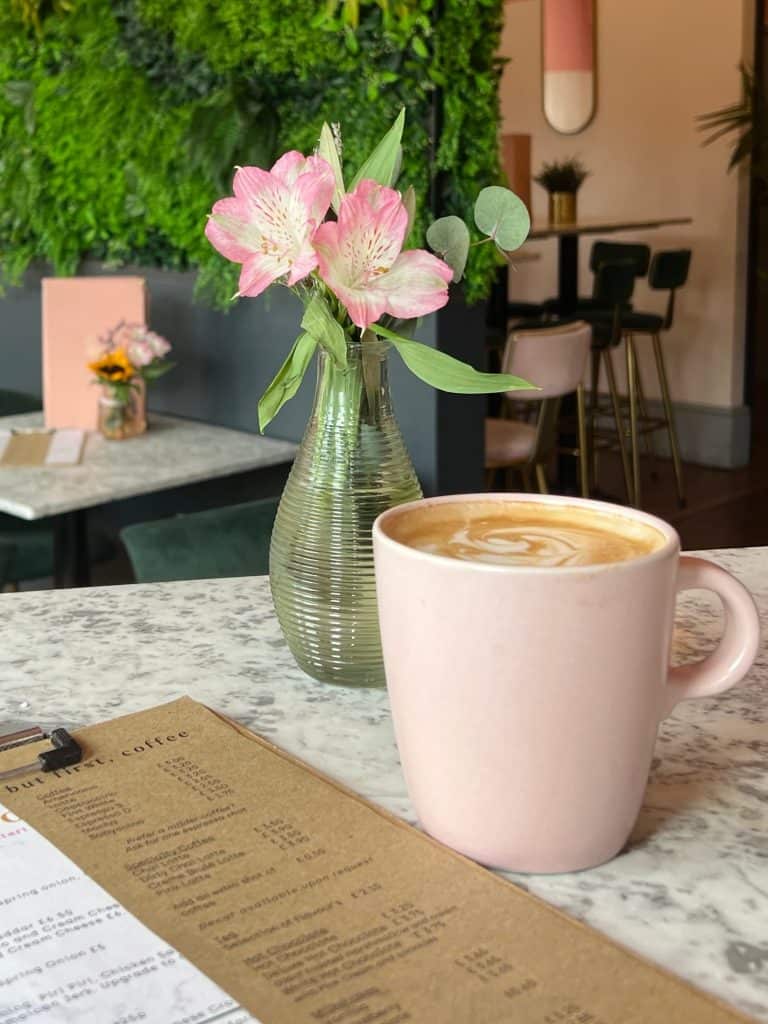 Latte in. a pink cup at Audrey by Day in Leicester