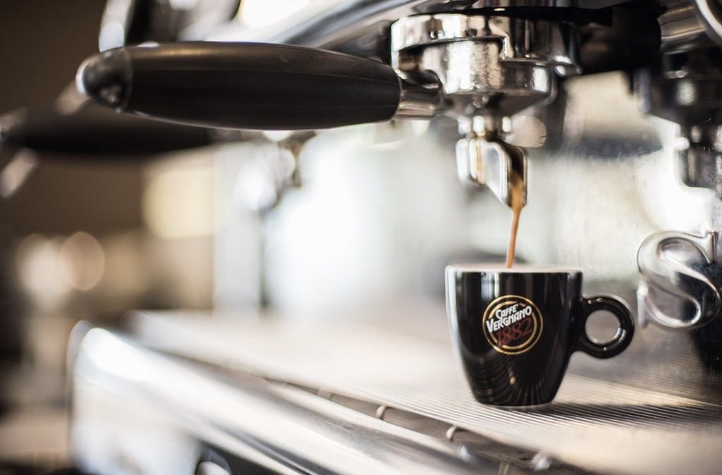 Gelato Village Espresso, LE1, Leicester. Black espresso cup with coffee being poured from machine