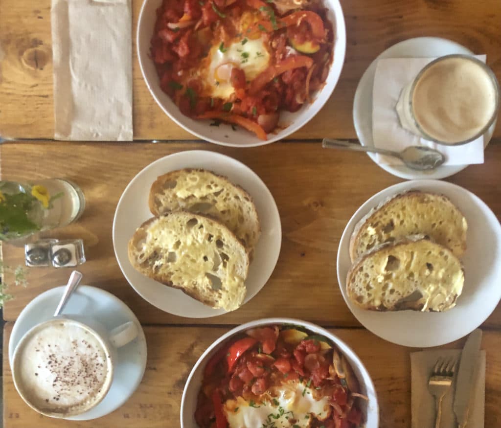 Kai Kitchen. Leicester top lay with 2 shakshukas and sliced and buttered sour dough