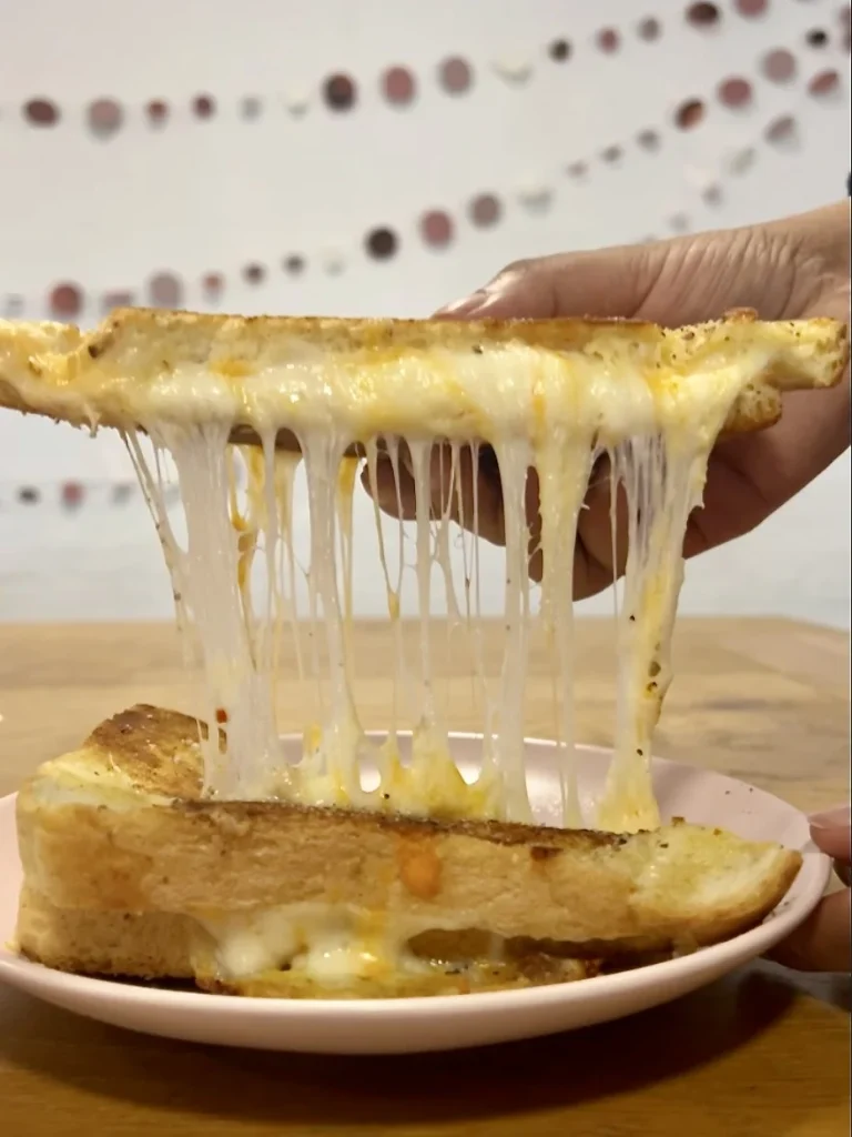 Grilled cheese toastie cheese-pull at Bitsys Emporium, Leicester