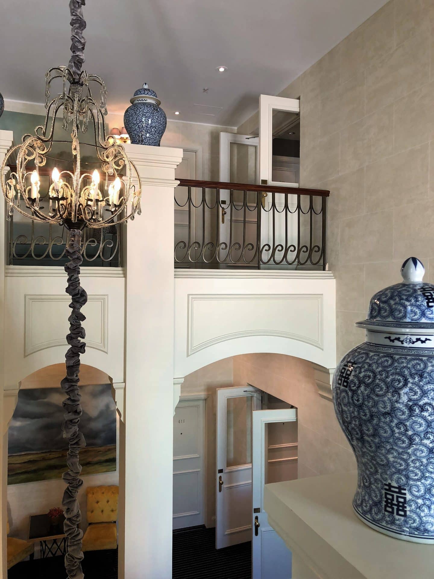 The Grand Palace Hotel Riga hallway with white and blue china pot and chandelier 
