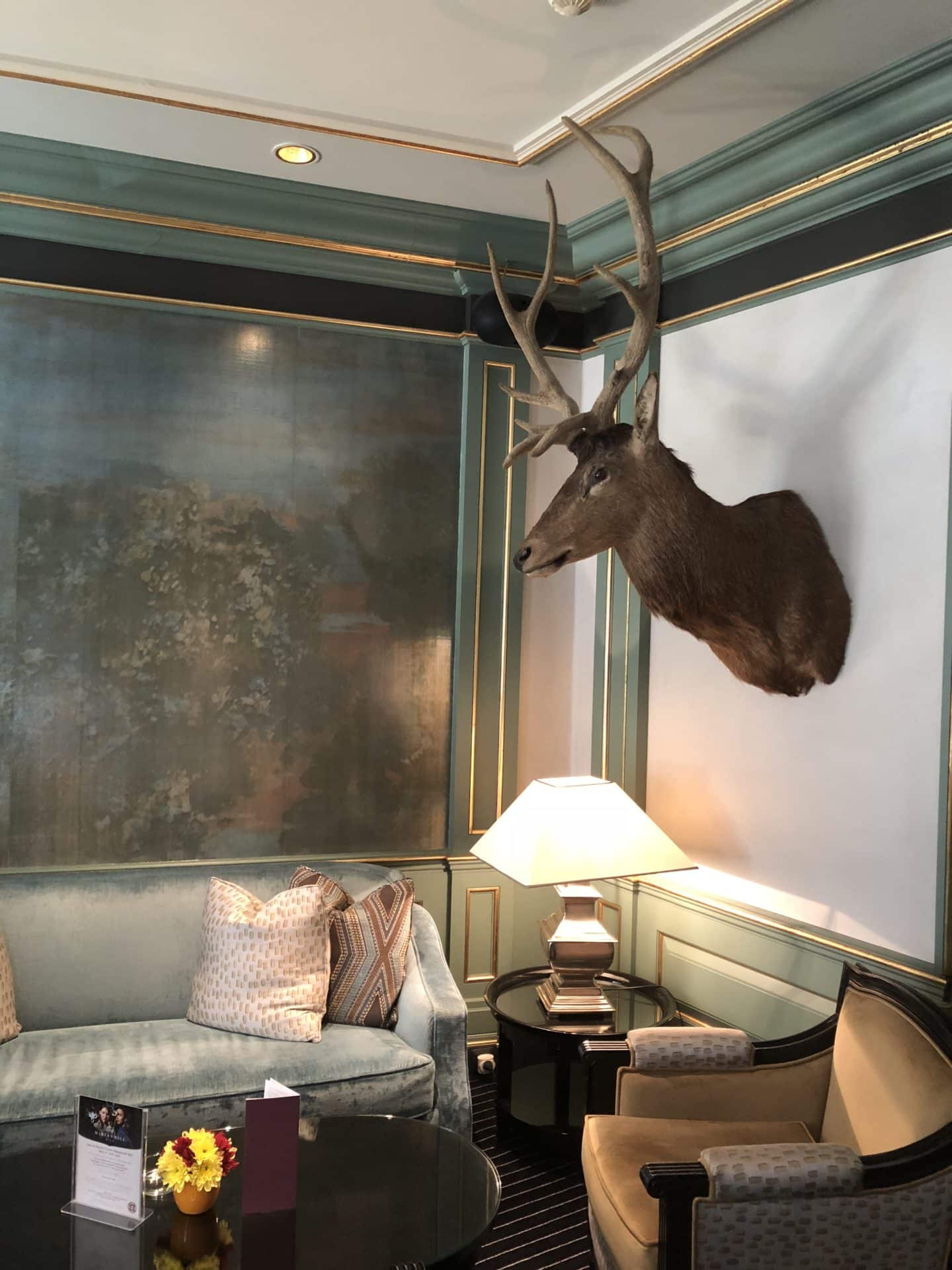 The Grand Palace Hotel Riga, Pils bar with sofas and armchairs and a stags head on the wall