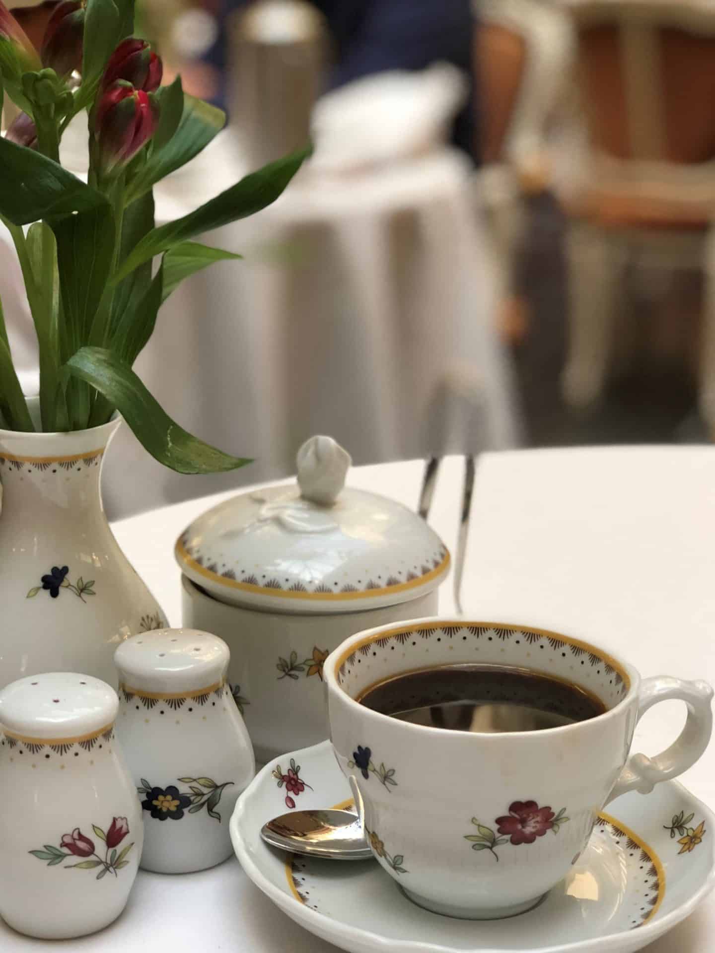 The Grand Palace Hotel Riga black coffee in white and floral painted crockery.