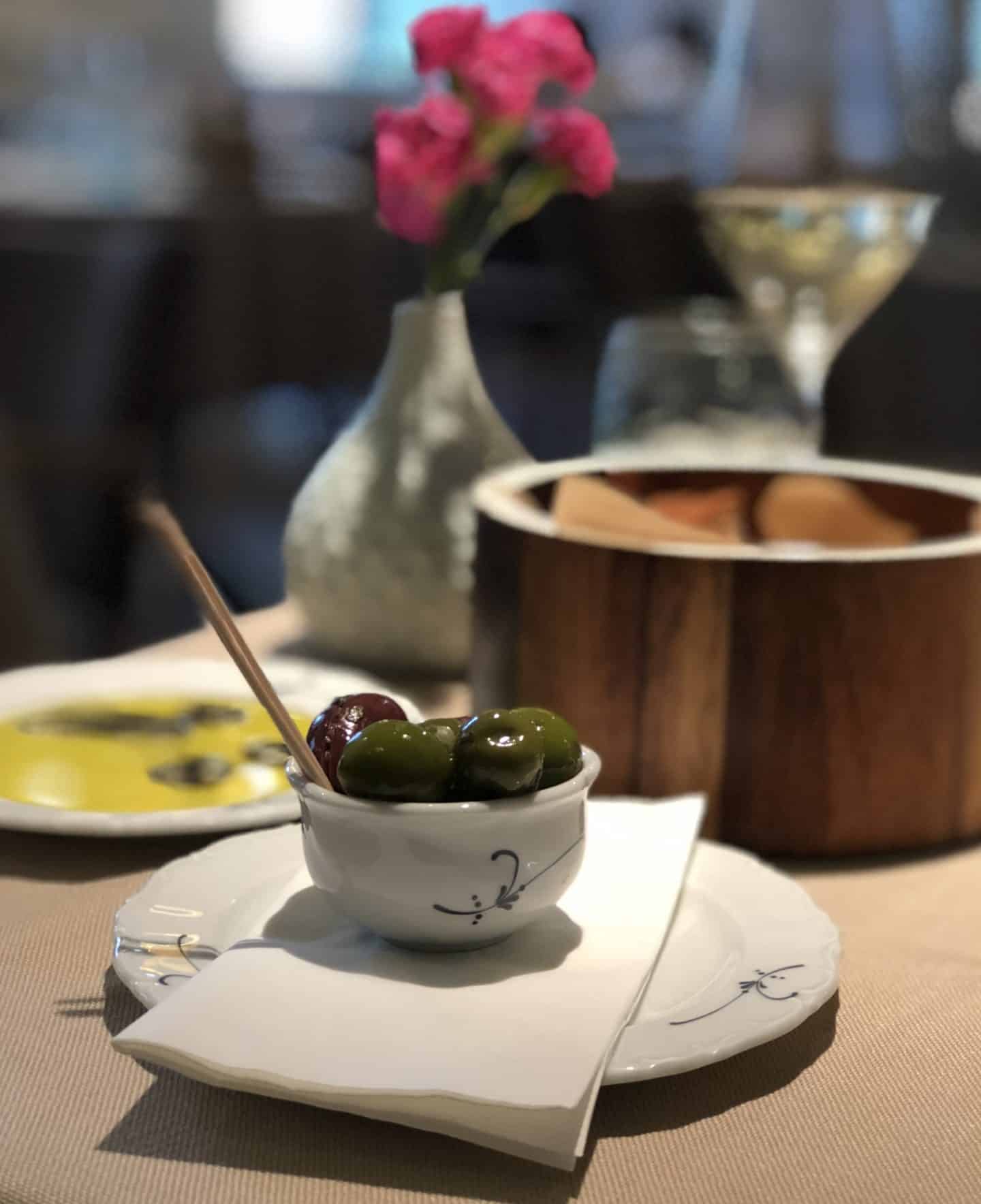 Vegetarian-friendly food in Riga: small bowl of olives at Riviera restaurant