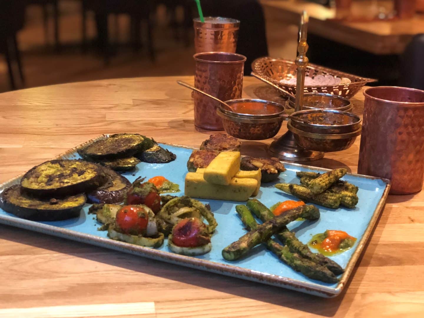Herb Restaurant, Leicester vegetable starter platter for sharing. There are copper drinking glasses and dips in the background