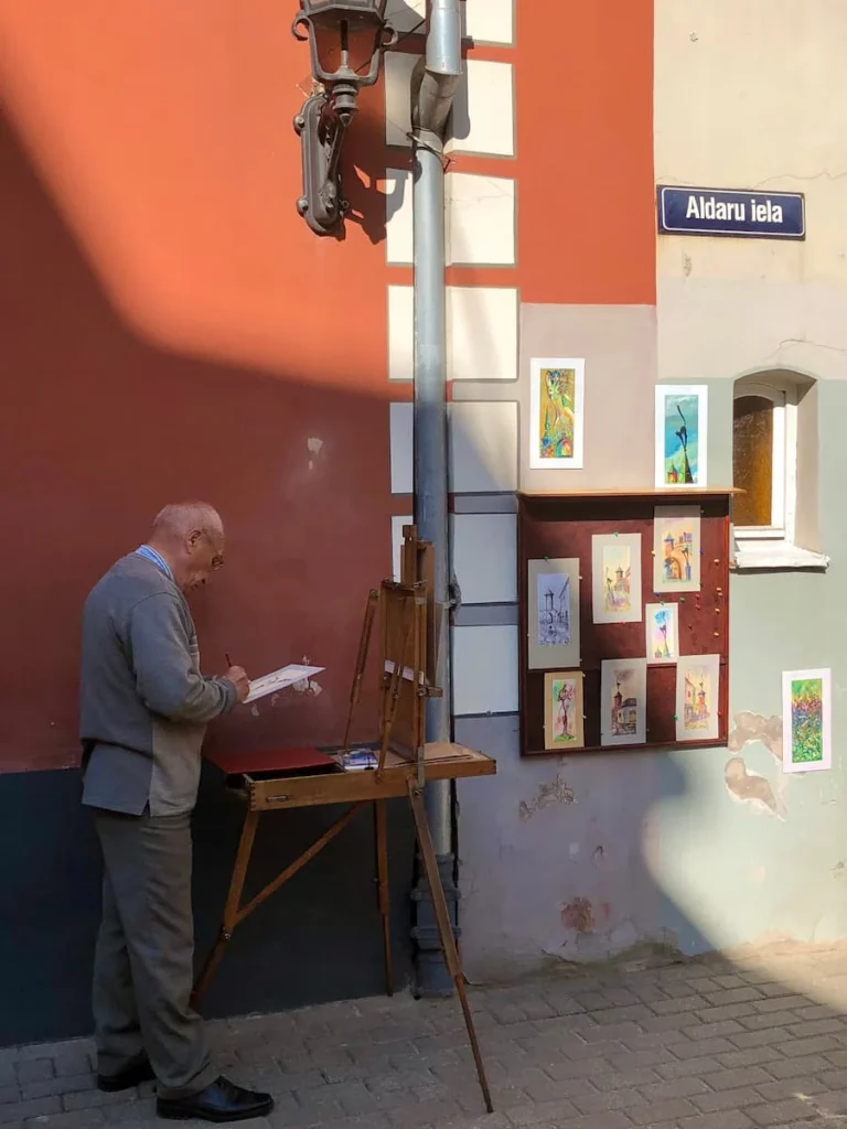 Man drawing on just outside of Trokšņu iela during a walk spending 3 days in Riga