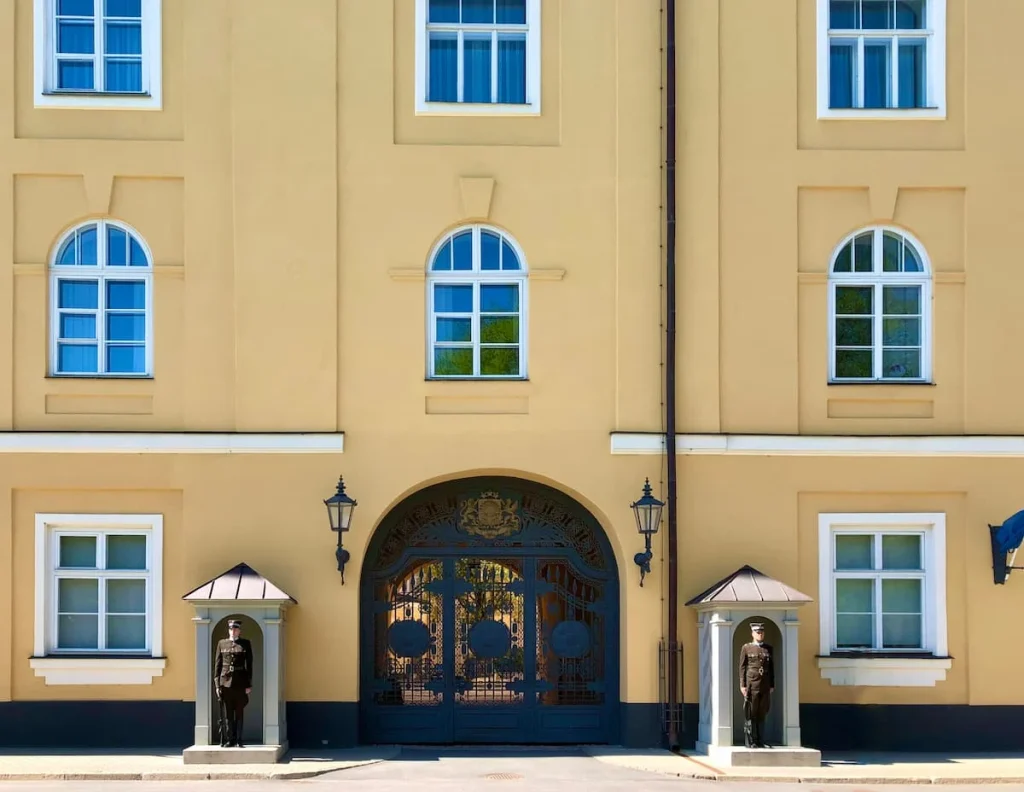 Cream building with guards outside, Riga Old Town