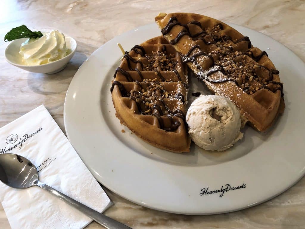 Heavenly Desserts, Loughborough. A waffle drizzled with ice-cream with a scoop of ice-cream and a swirl of cream on the side