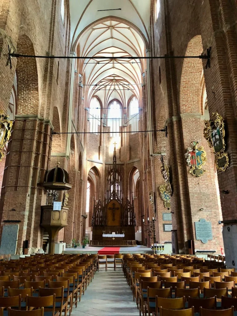 Inside St.Peter's church, Riga. Huge gothic windows and seating on either side for the congregation