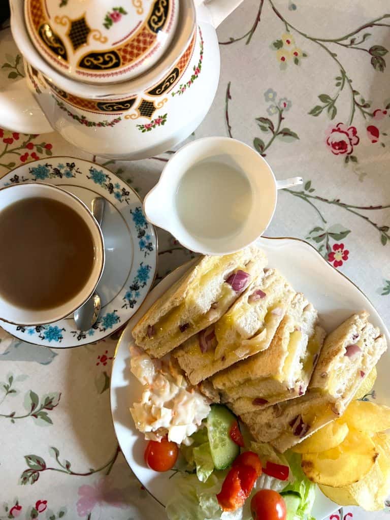 Miss B's Tearoom teapot. teacup and cheese and onion toastie