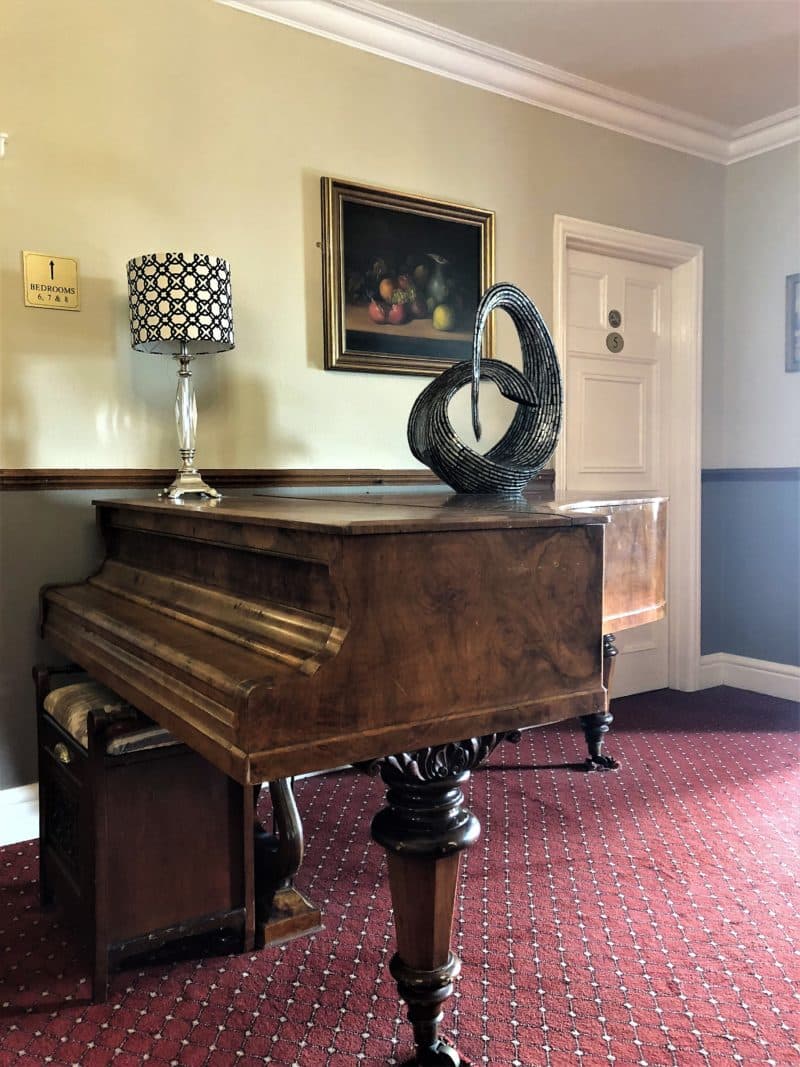 The piano outside The Colonel Pitt Room at Sysonby Knoll Hotel