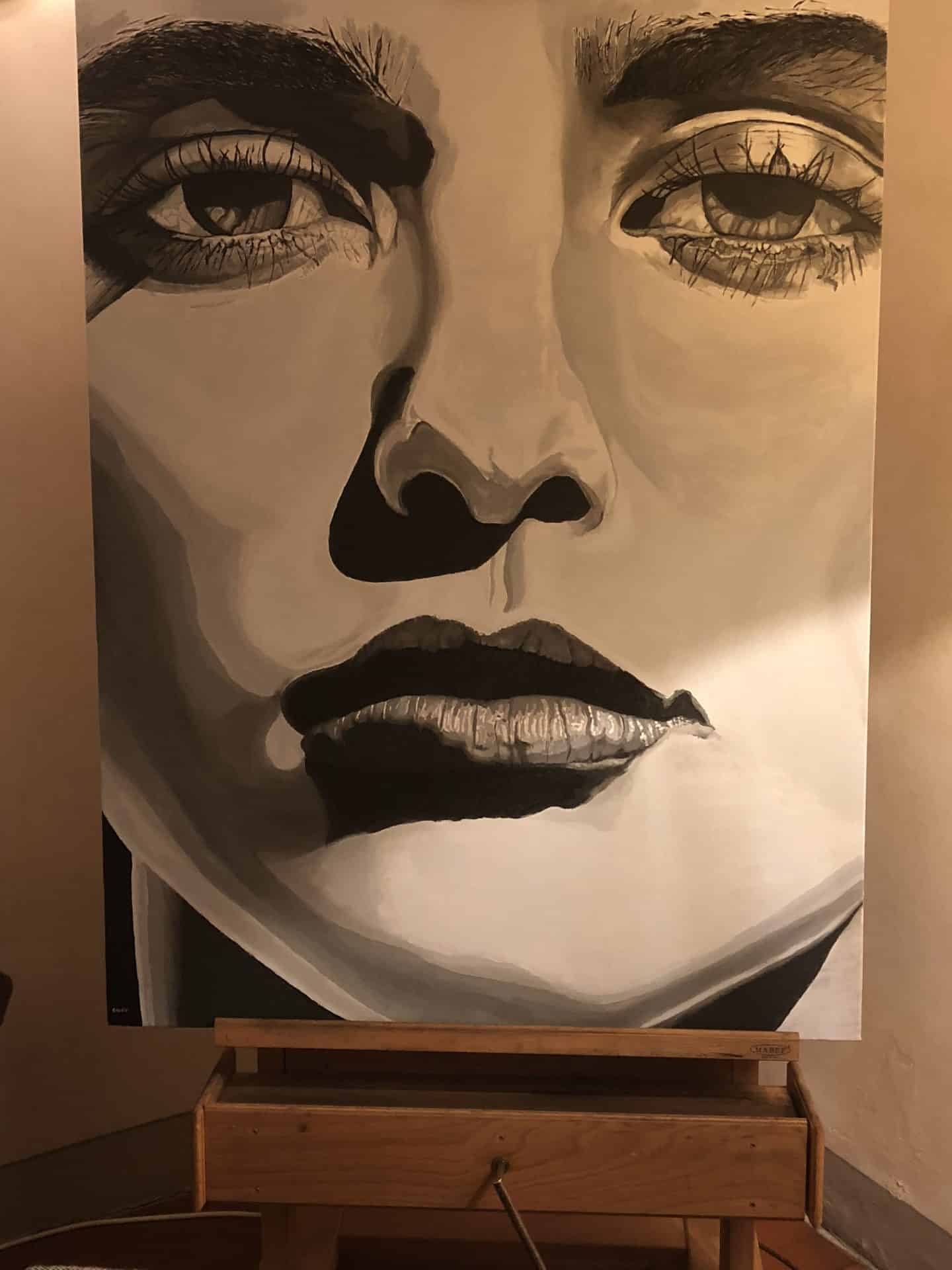 Belmond Villa San Michele: A painting on the walls of the holtel which is black and white of a women. There is a side console table un dark wood underneath it.