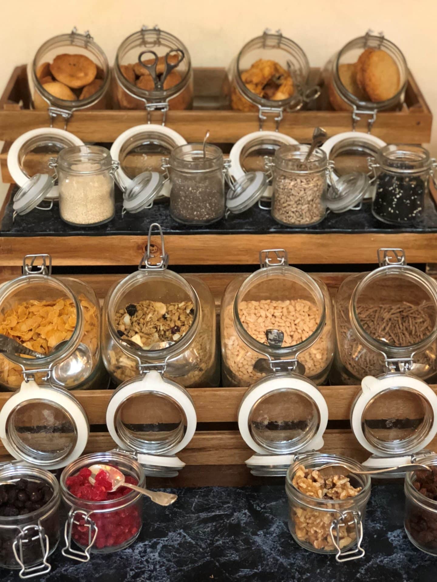 Kilner-style jars of different fruits and cereals stacked on tray shelves ready for breajfast at Belmond Villa San Michele, Fiesole.