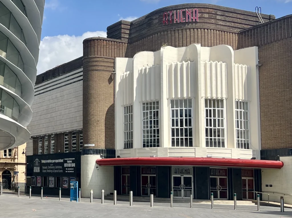 A Locals Guide to Historic Leicester Exterior of The Athena venue in Leicester's cultural quarter. The art deco-building has a red rim on the entrance and 1920's style windows.