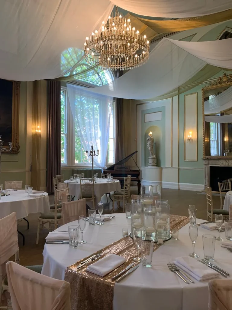 City Rooms Ballroom, Leicester with a piano, chandelier and the room being dressed with drapes fro a wedding recption