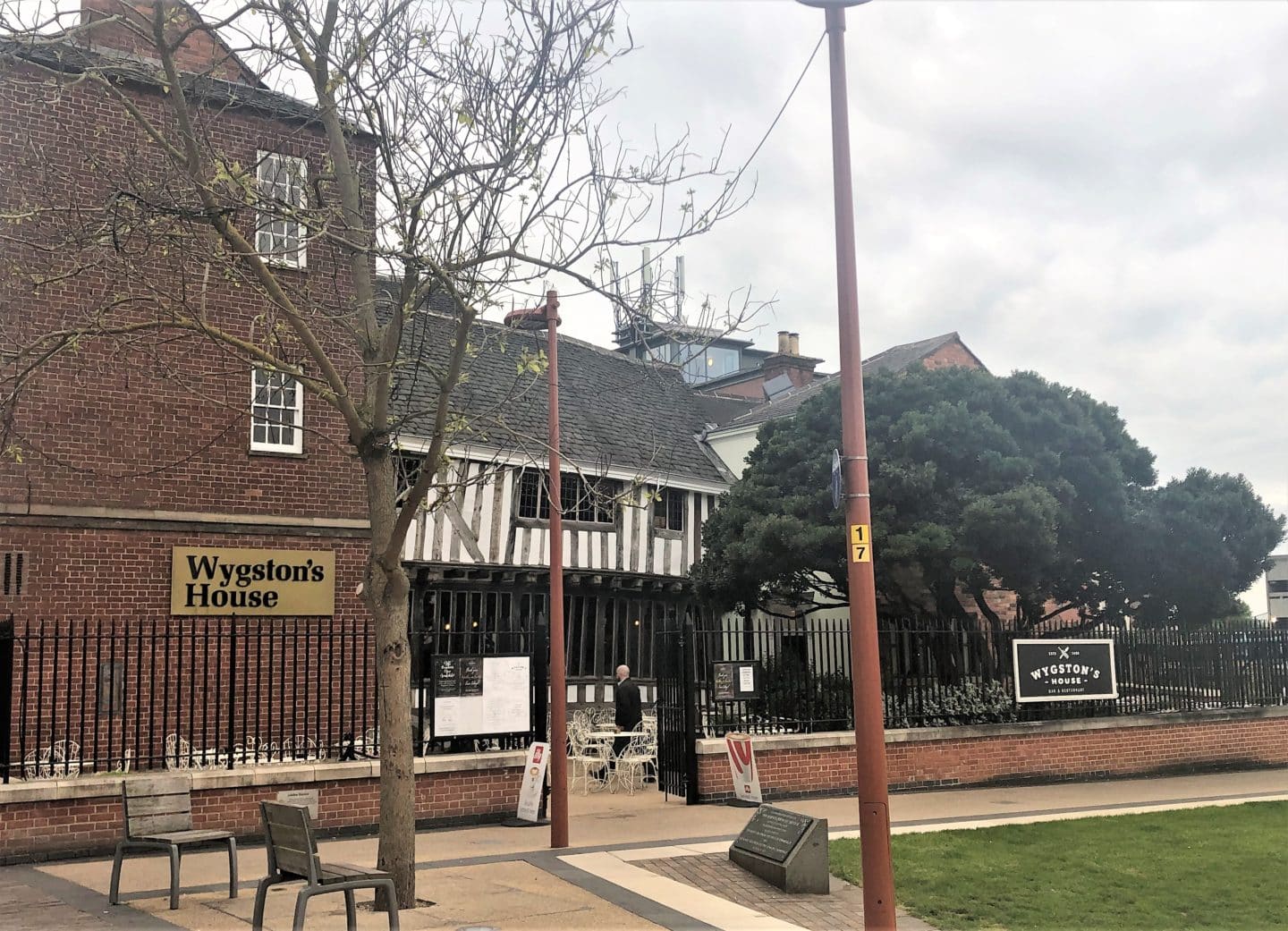 The exterior of Wygston's House Bar & restaurant, Leicester with the Tudor black and white architecture> Theer is seating outside on Jubilee sqaure as well as a green lawn right outside.