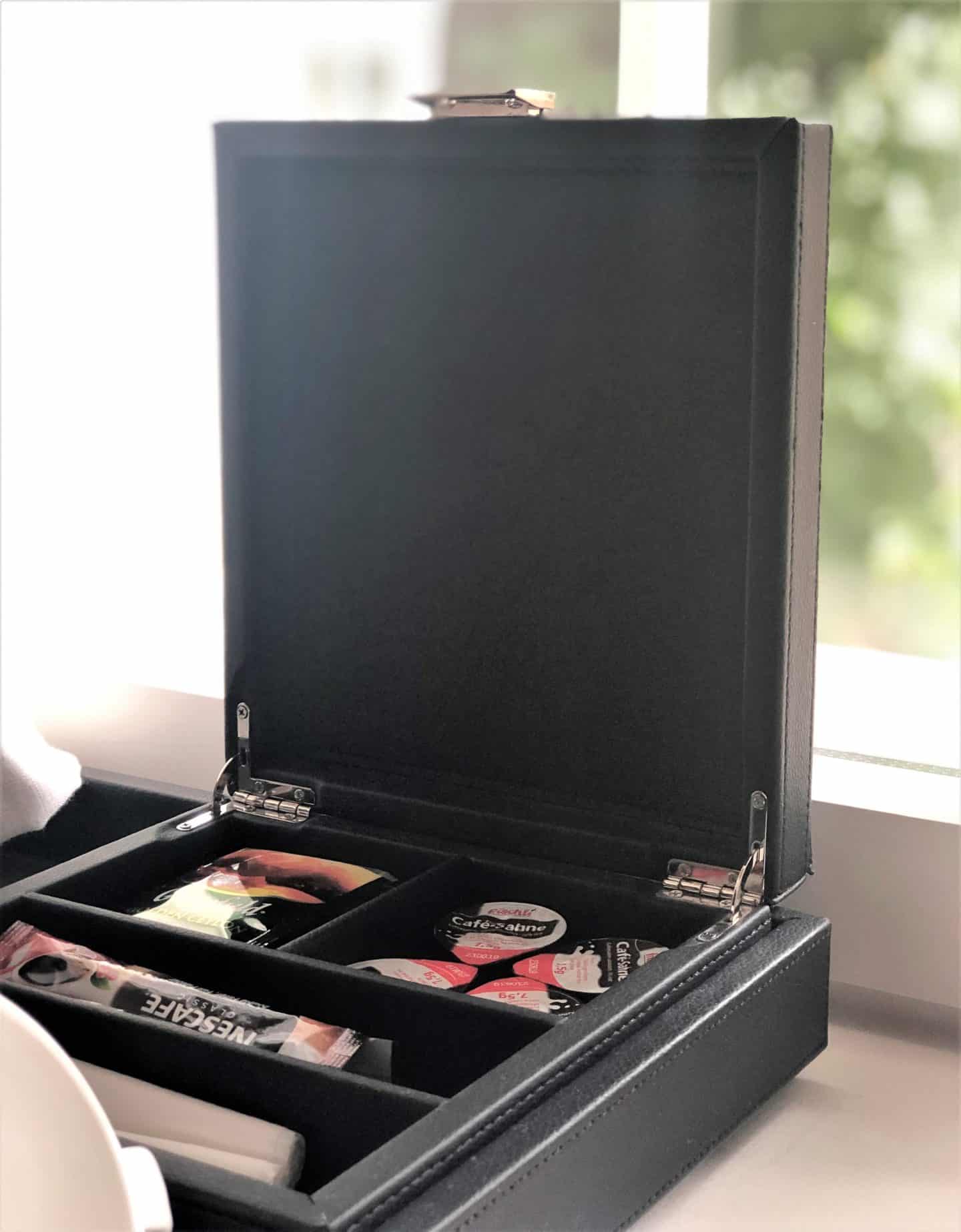 The Schlossle Hotel Tallinn: A brown leather box, containing coffee and tea sachets in the deluxe garden suuite room.