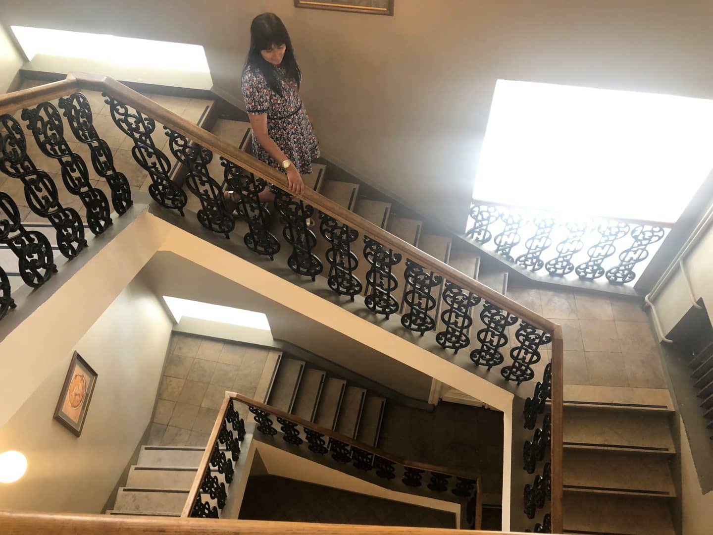 Bejal walking down the pretty stairs of the Maiasmokk cafe in Old Town Tallinn 