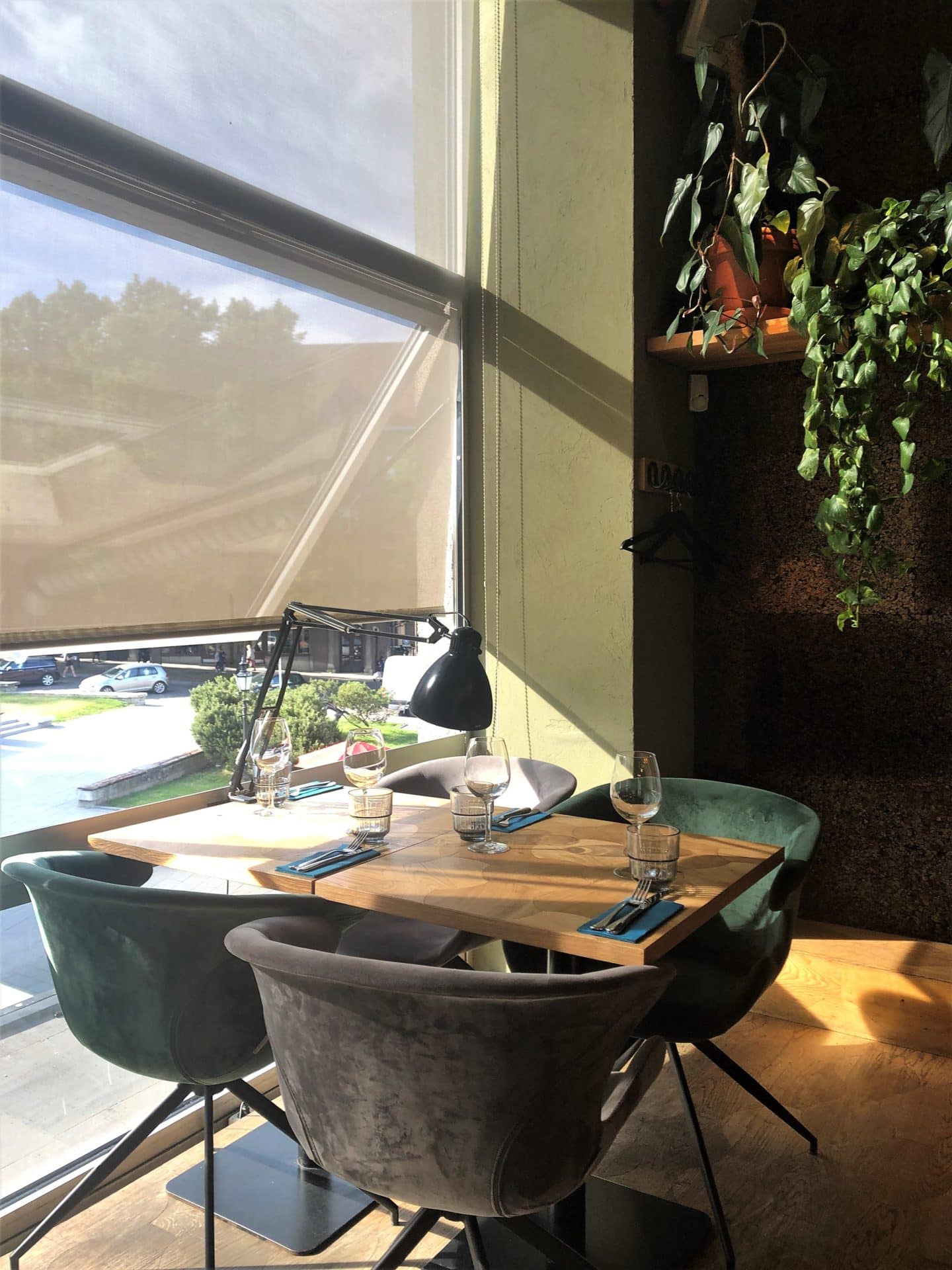 Vegetarian food in Tallinn, interiors of Pegasus restaurant with a table next to the window looking out on to the square