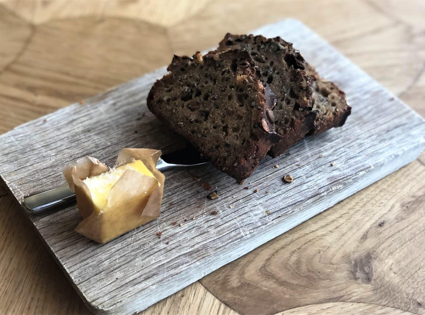 The house bread made with beer, pumpkin seeds and hemp seeds on a wood board at Pegasus Restaurant, Tallinn