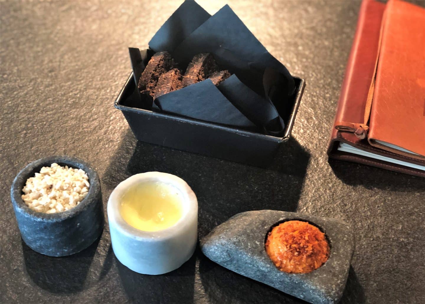 A selection of house breads with flavoured butters and salt at Noa Chef's Hall, Tallinn