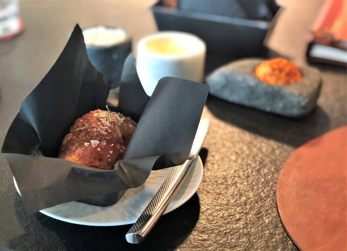A close of the selection of house breads with flavoured butters and salt at Noa Chef's Hall, Tallinn
