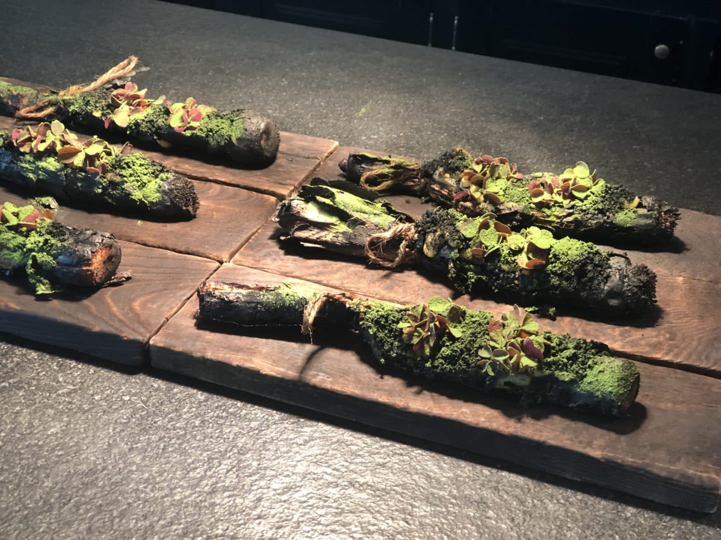 Vegetarian food in Tasllinn. Grilled leeks stuffed with truffle oil, buttermilk, black truffle, spinach with a slight dusting of breadcrumbs 