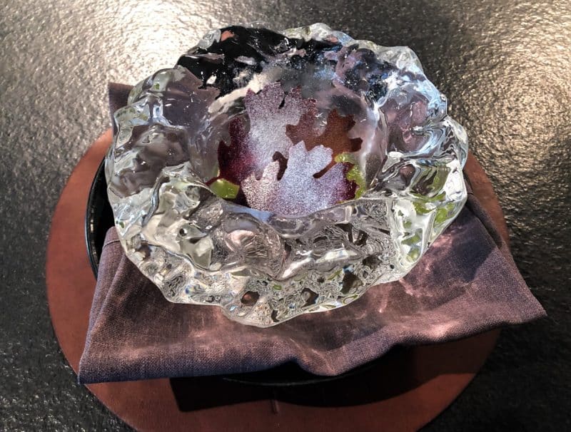 Kombucha pickled pears with apple and juniper (palette cleanser) at Noa Chef's Hall Tallinn. The dish is a beautiful light purple colour