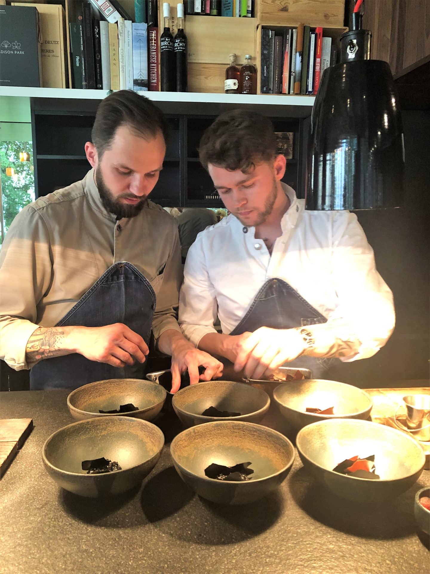 Head chef Orm and sous chef, Roman preparing dishes at Noa Chef's Hall in Tallinn